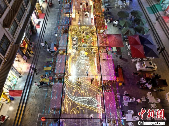 圖為明清街夜市燈光點亮具有武威文化元素的“天梯山石窟”彩燈。(無人機照片) 　戴文昌 攝</p><p>